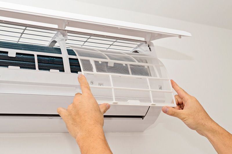 Image of someone changing filter on ductless system. What Maintenance Is Needed for a Ductless System.